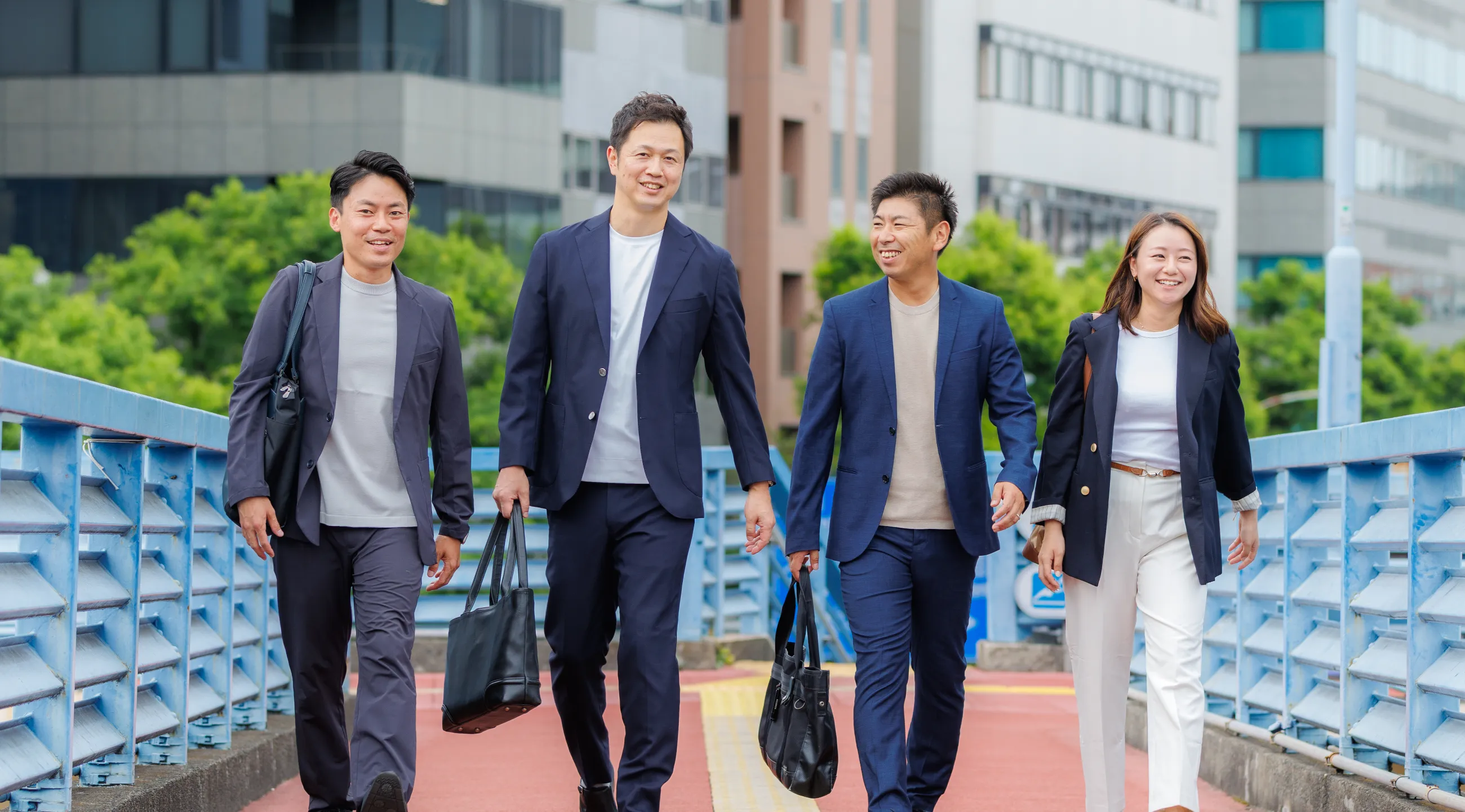 街を歩くTOSHITATEのスタッフ4人